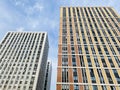 Moscow, Russia, August 2021: Close up of new multi-storey apartment block houses. Mortgage concept. Tall as skyscrapers. Blue sky Royalty Free Stock Photo