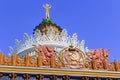 Moscow, Russia - August 01, 2018: Coat of arms of Ukrainian SSR against the backdrop of gilded spire with soviet star on facade of