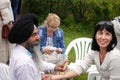 An elderly bearded Indian in a black turban gives a woman an acupressure of the hand