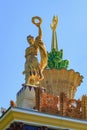 Moscow, Russia - August 01, 2018: Figure of woman of collective farmer against gilded spire with soviet star on roof of pavilion U