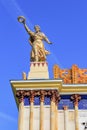 Moscow, Russia - August 01, 2018: Figure of woman of collective farmer with sheaf and wreath on roof of pavilion Ukrainian SSR aga