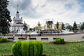 MOSCOW, RUSSIA - AUGUST 10 2014: Fountain Friendship of people and Central House of Russian people at VDNkH Royalty Free Stock Photo