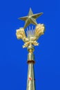 Moscow, Russia - August 01, 2018: Gilded soviet star closeup on a blue sky background on spire of the tower of pavilion Central on