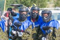 MOSCOW, RUSSIA - AUGUST, 2017: Paintball sport players in protective uniform and mask playing and shooting with gun outdoors. Royalty Free Stock Photo