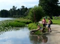 People are bathing dogs in the pond of the park `Kuzminki-Lublino`