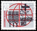 Postage stamp printed in Germany shows Stylized ears of corn, seeds, cross and inscription, circa 1963
