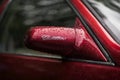 MOSCOW, RUSSIA - AUGUST 26, 2017: Rear view mirror from with logo on a vintage red Cadillac car close-up, selectiv focus Royalty Free Stock Photo