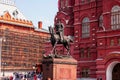 MOSCOW, RUSSIA - AUGUST 10, 2021: Red brick Russian State Historical Museum facade with the monument to Marshal Georgy Zhukov.