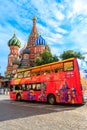 Red sightseeing double decker bus near St. Basil`s Cathedral on Red square in Moscow, Russia Royalty Free Stock Photo