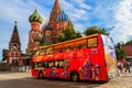 Red sightseeing double decker bus near St. Basil`s Cathedral on Red square in Moscow, Russia Royalty Free Stock Photo