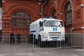 On Red Square, behind the fence, there is a police car for transporting detainees and police officers