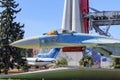 Moscow, Russia - August 01, 2018: Russian fighter SU-27 on a background of Vostok booster rocket against blue sky closeup on Exhib