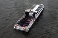 MOSCOW, RUSSIA - AUGUST 24, 2020: Single-deck motor ship conducting a river cruise on the Moskva River. Tourists listening to