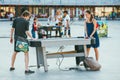 Moscow, Russia - AUGUST 9, 2014: teens play air hockey on a table in a Sokolniki park amid other playing people