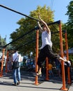 An unknown street athlete performs exercises on Poklonnaya Hill.