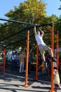 An unknown street athlete performs exercises on Poklonnaya Hill.