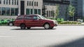 Volkswagen Golf Variant car with a rusty decayed front fender riding on the city street. outdated red Volkswagen Golf Mk3 estate Royalty Free Stock Photo