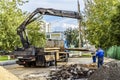 Workers and technicians perform repair work on the road.