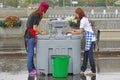 Young women washing dishes in rainy weather in Gorky Park in Moscow