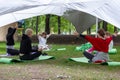 MOSCOW, RUSSIA - AUGUST 02, 2019: Young women yoga practitioners in group doing yoga on nature