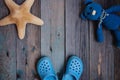 Moscow, Russia - 05.28.2018: baby beach Slippers starfish Teddy bear on wooden table