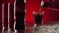 Moscow, Russia - 14 04 2020: Cinematic commercial shot of coca cola pouring in glass with ice cubes and rack focus on Royalty Free Stock Photo