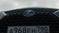 Moscow, Russia - CIRCA 2020: Big green SUV Lexus RX front logo and grill.