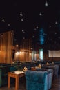 Moscow. Russia. Circa 2022. New designer cafe in loft style. Night photos of the institution. Natural wood tables and