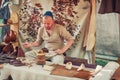 Moscow  Russia 06 10 2019: Cobbler in vintage shop repairing shoes. Artisan in the shop of a shoemaker makes boots Royalty Free Stock Photo