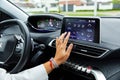 Moscow, Russia, 08.05.2018: Cropped rear view shot young woman in a car. One is driving, the other is using touch screen