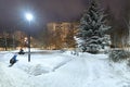 Moscow, Russia - Dec 4. 2023. Winter cityscape with multi-storey residential buildings and snow-covered fir trees