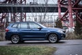 Moscow. Russia - December 06, 2019: The all-new BMW X3. Blue crossover stands on the street at night. Premium German SUV. Side