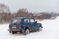 Blue Russian off-road car Lada Niva 4x4 VAZ 2121 / 21214 parked on the snow field.