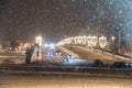 Moscow, Russia - December 27, 2022: Car drives down a snowy street in a cold and deserted Moscow on a dark winter evening