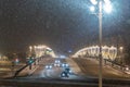 Moscow, Russia - December 27, 2022: Car drives down a snowy street in a cold and deserted Moscow on a dark winter evening