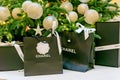 Moscow, Russia - December 15, 2021 - Chanel logo on black paper bags with presents under christmas tree. Luxuary brand of clothes