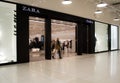 Moscow, Russia, December 2020: Entrance to the Zara store. A masked customer comes out with her purchases