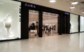 Moscow, Russia, December 2020: Entrance to the Zara store. A masked customer comes out with her purchases