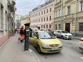 Moscow, Russia, December, 21, 2019. Female driver gets out of the car at the paid Parking terminal. Moscow, Lyalin lane