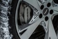 MOSCOW, RUSSIA - DECEMBER 04, 2021 Genesis GV80 JX1 brakes calipers close up.