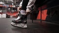 Moscow, Russia - December, 2020: Hockey player putting on skates. Action. Close-up of professional hockey player putting