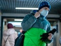 Moscow, Russia - December 6, 2019: Man with surgeon face mask respirator in passage near entrance to the Novye Cheryomushki metro Royalty Free Stock Photo