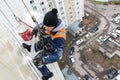 Moscow, Russia - December 18. 2018. Mountaineer employee of public services warms residential building.