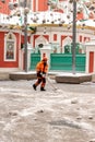 MOSCOW, RUSSIA - DECEMBER 15, 2020: Municipal city service cleans footpath from snow after blizzard in Moscow. Worker shoveling