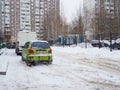 An old shabby scratched Daewoo Matiz car in a snowy courtyard in Moscow