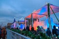 Moscow, Russia - December 2017: tents, garlands, highlighted ice sculptures, cloudy sky and crowd, Poklonnaya hill at winter.