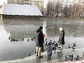 Moscow, Russia, November, 25, 2019. Family with two young children went out on thin autumn ice on Clean ponds Chistye prudy thro