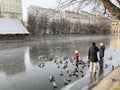 Moscow, Russia, November, 25, 2019. Family with two young children went out on thin autumn ice on Clean ponds Chistye prudy in M