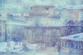 Raindrops on window glass with old town view background. Aerial view of Bank in rainy day