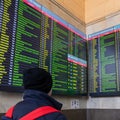 Moscow, Russia - Feb 20. 20201. teenager with backpack looks at train timetable at Kazansky terminus